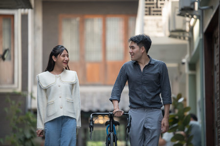 Asian young couple looking each other, male and female spending time togetherの写真素材