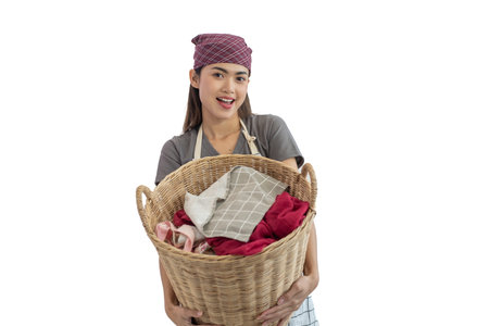 Young Asian woman carrying laundry cloth basket isolated on white backgroundの写真素材
