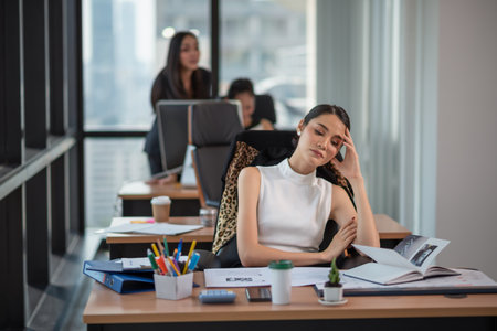 Portrait of stressed business woman with palm on face in her officeの写真素材