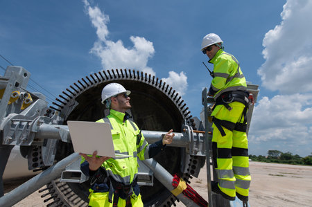 Wind Turbine Maintenance and Repair Technician, Engineer Checking Turbines working maintenance clean...