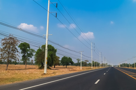 row of wire pole inside road on countryside
