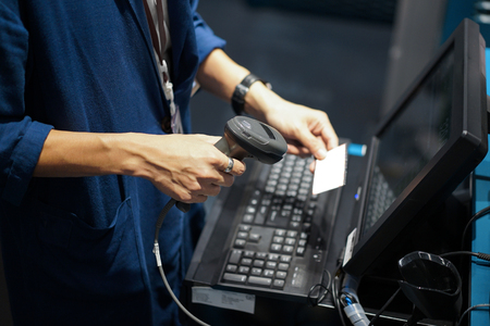 Point of sales shot, barcode or QR code scanning front of computer.の写真素材
