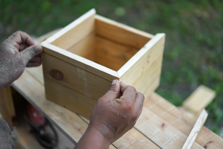 close up wooden square box are created by Asian hand man.の写真素材