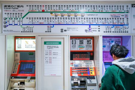 Osaka, Japan - 28 Feb 2018: Passenger was buying the train ticket in front of machine at Sakaihigashi Stationのeditorial素材