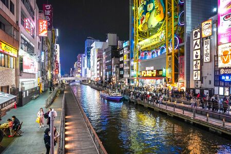 Osaka, Japan - 28 Feb 2018: Tourists and local people was around cannel near Shinsaibashisuji Shopping Street, someone was waiting for boat traveling, and some was walking for shopping.のeditorial素材