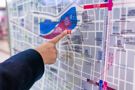 Osaka, Japan - 3 Mar 2018: Traveler reads and point to the Japan's subway metro train map on the board., in Osaka area, Japan.のeditorial素材
