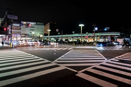 Sakaihigashi, Osaka, Japan - 28 Feb 2018, A lot of car in line was wating for traffic light and crownd walked trough at the juction and zebra line.のeditorial素材