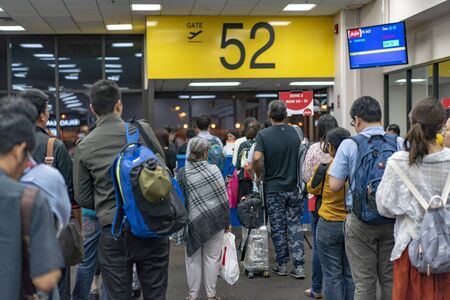 Bangkok, Thailand - 27 Apr, 2018: Asian tourists pulled belonging in the Donmuang international airport to the plane at gateway., Bangkok, Thailand.のeditorial素材