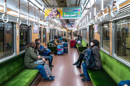 Osaka, Japan - 3 Mar 2018: Passengers walk and sit in the local underground Japan Train no. 8984 and going to the next train station, Namba, Osaka, Japanのeditorial素材