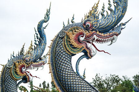 Beautiful blue turquoise statue King of snake front of Thai temple. In Buddhist tales, It wanted to be a monk but it can not. Because it's not human.の写真素材