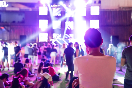 backside of the guy who face to mini concert stage.の写真素材