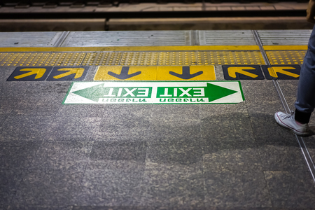 Thailand Airport Rail Link platform at Phaya Tai station, in the night Bangkok. Thai letter meaning...