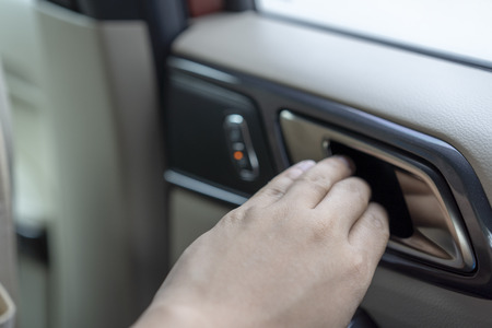 man hands to open the door car from inside.