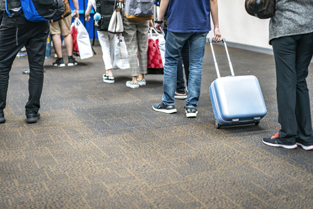 Asian tourists pulled belonging in the international airport to the plane at gateway.の写真素材