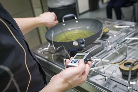 Thermometer measure the degree of oil fried in the pan.