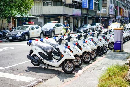 Taipei, TAIWAN - 3 Oct, 2017: Taiwan Police cars and motocycle were parking beside the street near...