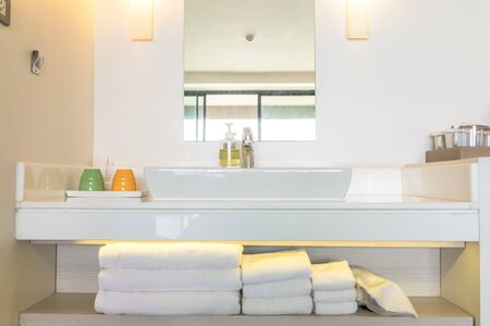 Toiletries are arranged in the shelf under the sink ready for resort client to use.の写真素材