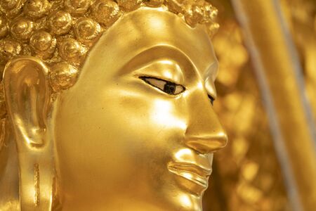 Close up gold Buddha statue FACE for background.の写真素材