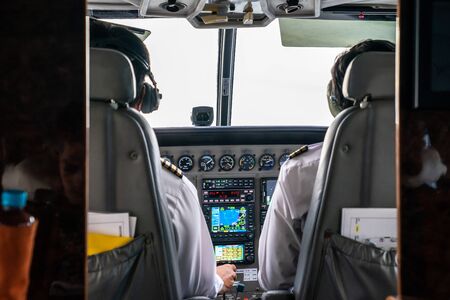 close up 2 pilots concentrate drive the small private jetplane on the sky.の写真素材