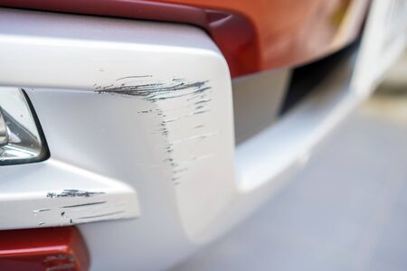 Close up New Scratch damage on the front of New red car.の写真素材