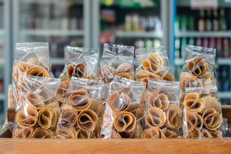 "Thong Muan" is a type of rolled wafer, a traditional dessert in plastic back packaging in local convenience store in Thailandの写真素材