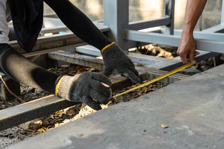 Workers are measuring the floor of toilet before construct and process next stepの写真素材