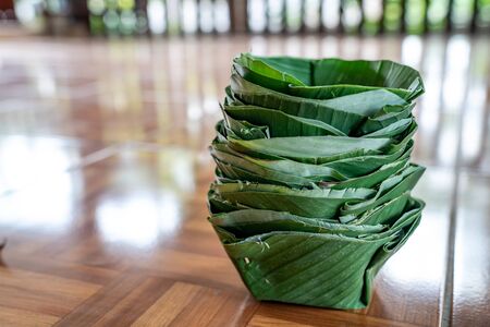 Local and traditional TRAY FOOD (eco prackaging) made to dish and bowl from banana leaf, arranged together like a tower.の写真素材