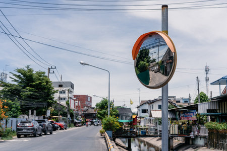 Chonburi Province, Thailand - 30 Jul 2020, The local road with little canal with the normal building around it at mid day in the rural area, Chonburi Province, Thailand.のeditorial素材