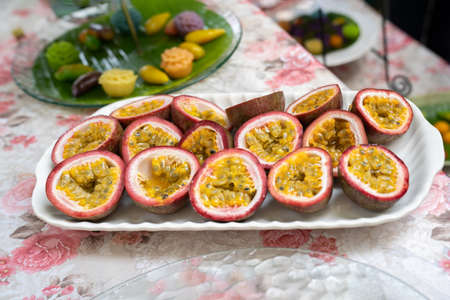 the Half of Passion Fruit on the dish, ready to serve and eat.の写真素材