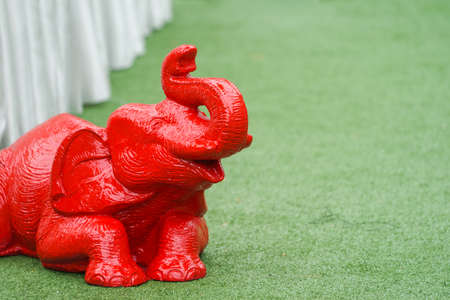 Asian Elephant statue figure sit and lay on the green turfの写真素材