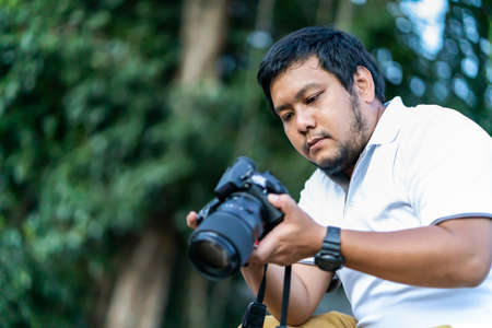 Asian beard Thai professional camera man check image shot via liveview behind Medium format...