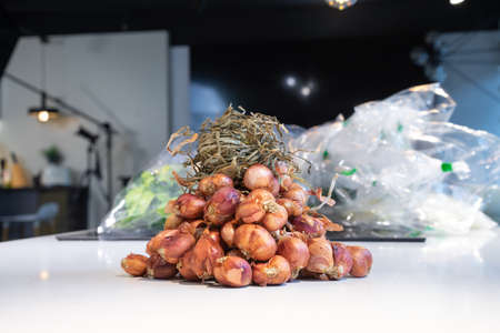 red - purple shallot Bundle in studio light on the white marble surface table