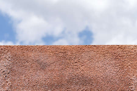 polyurethane foam wall texture with blur blue open sky background.の写真素材