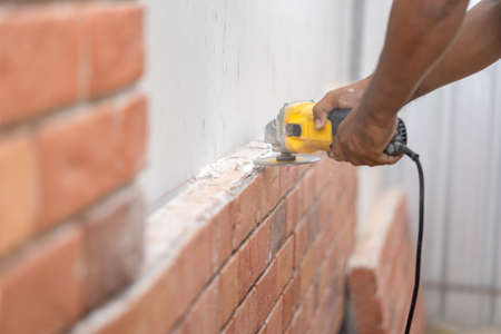 Close up to Grinder Machine in Worker man hand hold saw, grind, check and kept detailed polyurethane...