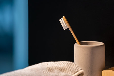 Closeup to Wood Toothbrush in the mug and in front of black background.の写真素材