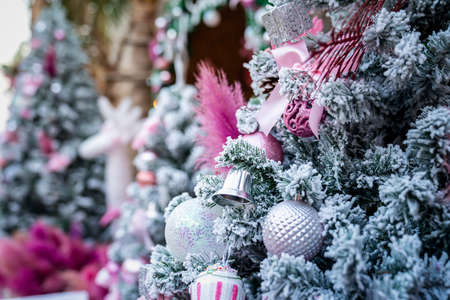 Christmas Tree with snowflake is decored with ball, presents and gift in pink theme for Christmas and new year eventの写真素材