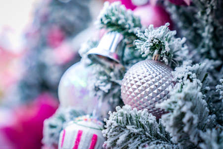 Christmas Tree with snowflake is decored with ball, presents and gift in pink theme for Christmas...