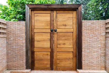 Wooden door and wood frame with the Bronze Knocked Chinese Lion head style on it. This is middle of...