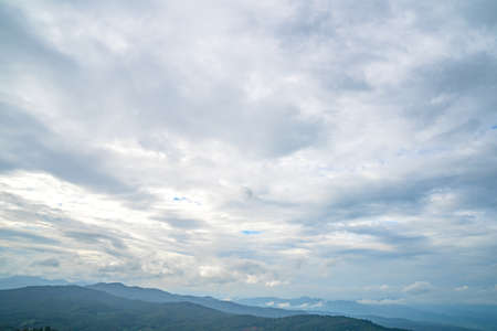 it takes time to walking up mountains which full with plants and animals. Then reach top of hills looking up to cloudy sky and panoramic views on countryside.の写真素材