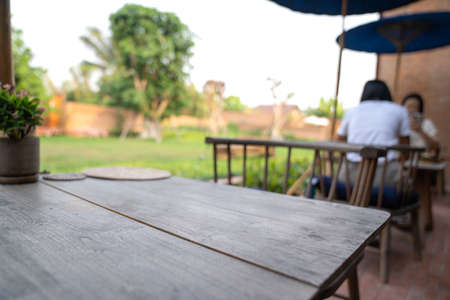 blur Thailand Northern traditional modern combination wood table and chair set with wicker plate on it in the garden blur backgroundの写真素材