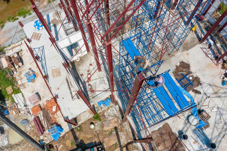 Dual Asian Welder and blacksmith work on the height scaffolding, Shoot from above of them.の写真素材