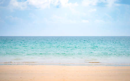 Minimal Sand Sea Sky on the Kata beach at Phuket Island, Thailand, Shoot by Tele Lens zoom in to little wave on it with blur blue sky and cloud.の写真素材