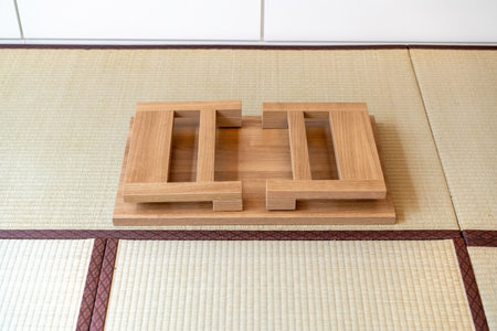 A Japanese folding table made of wood is set at the center of the picture, suitable for eating or...