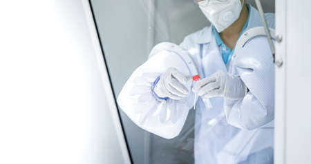 Hands of medical personnel holding a nasal swab ATK is collecting germs from a negative pressure...