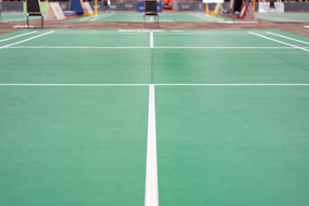 empty green used badminton court background is ready for playing badminton in competition or...