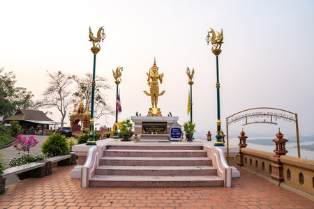 ChiangRai, Thailand - 26 Mar 2021, A golden graven image standing with a sword and rowel in his hand. He was standing on golden bases against a white backdrop.のeditorial素材