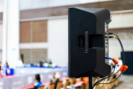 The black speaker set against a white wall with blurred background is used for voice acting in sports stadiums. The sound is clear and loud, so the action of the match can be heard clearly.の写真素材