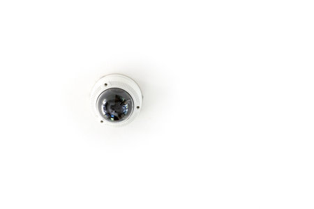 CCTV with the dome is hung on a white ceiling for circuit television guard protection.