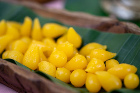 ThongYod (Golden Drop) Traditional Thai Desserts on banana leaf in wood bowl.の写真素材