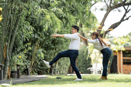 Asian Woman Grabbing and Catching Man shoulder and bracing the man to live with her.の写真素材